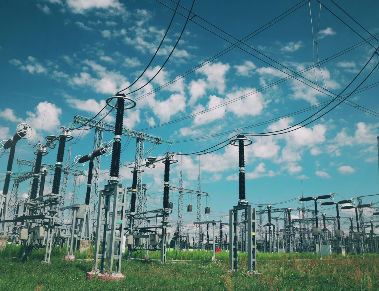 Power Grid Station. Electrical Distribution Station, Transformers, High-voltage Lines In Sunny Summer Day.